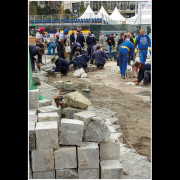 During the official opening of the reconstructed Republic Square in Belgrade, after more than 400 days of construction, it was publicly stated that the newly installed granite paving stones would last for centuries.

Only a few days later, the stones began to sink and shift. What followed was an unplanned intervention — lifting, turning over, and gluing the granite blocks back into place.

This photograph documents the contrast between political declarations and material reality, capturing a moment where urban space becomes a visible record of improvisation, repair, and contradiction.

The image stands as a visual testimony to contemporary public works in Serbia, revealing how permanence is often promised, while temporariness becomes the lived outcome.