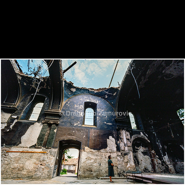 Six months after the Yugoslav People’s Army entered Vukovar, I returned to document the city in the aftermath of destruction. There were no longer tanks or fighting in the streets, but the silence that had settled over the city was overwhelming. Ruins dominated the urban landscape, while reconstruction had begun only in isolated cases.
This photograph shows the interior of a heavily damaged church — roofless, stripped to bare walls, and marked by destruction — bearing witness to the scale of devastation and the sudden absence of everyday life.