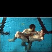 Photograph taken in 2002 during the rehabilitation of a young boy who survived a severe electrical accident.
The image focuses on a quiet moment of physical support and trust, revealing intimacy, vulnerability, and human care during recovery.