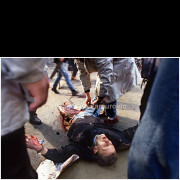 Wounded demonstrator lying on the pavement during violent clashes between police and protesters in central Belgrade on March 9, 1991.